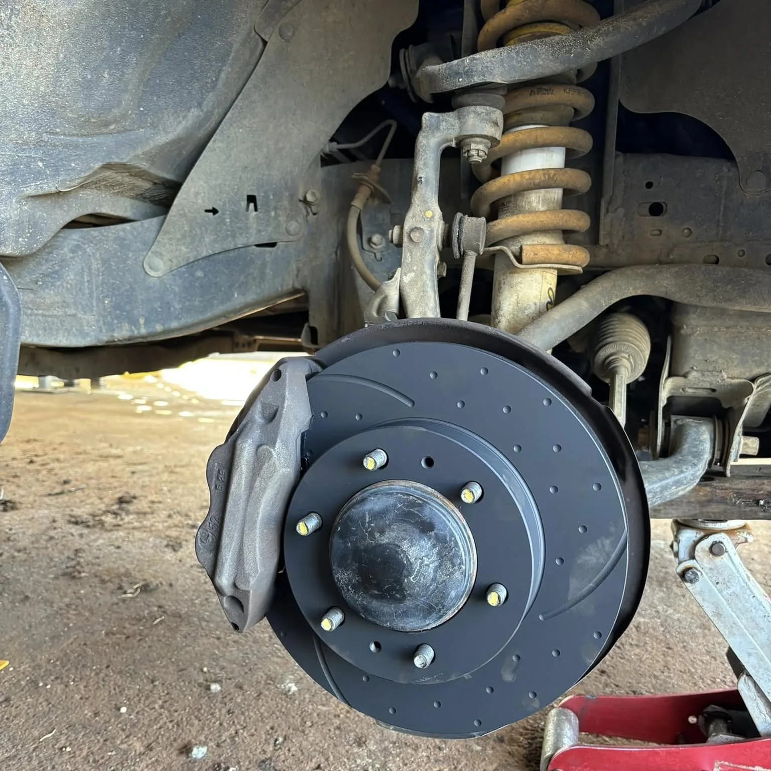 New slotted brake rotor and caliper fitted to a four wheel drive