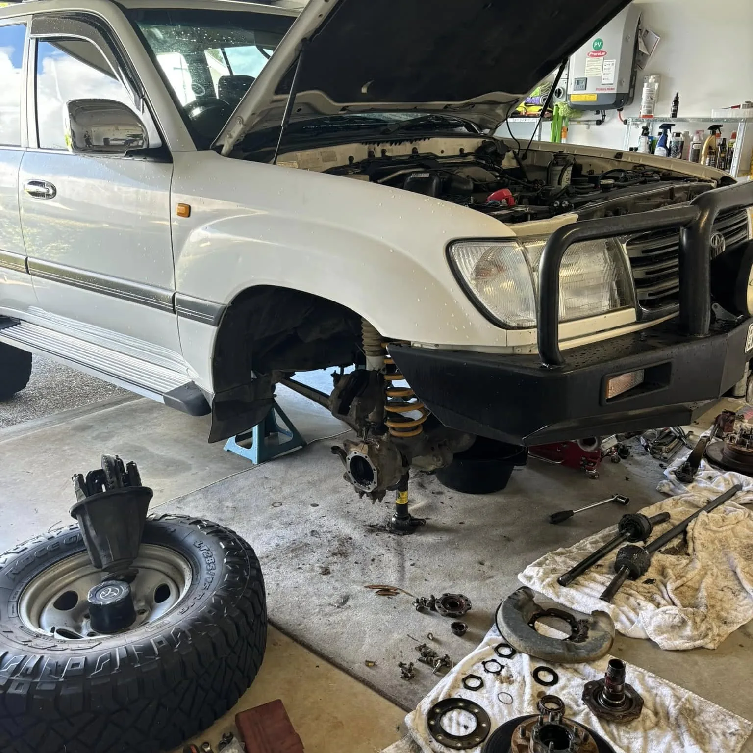 100 Series Landcruiser up on stands with the front end apart