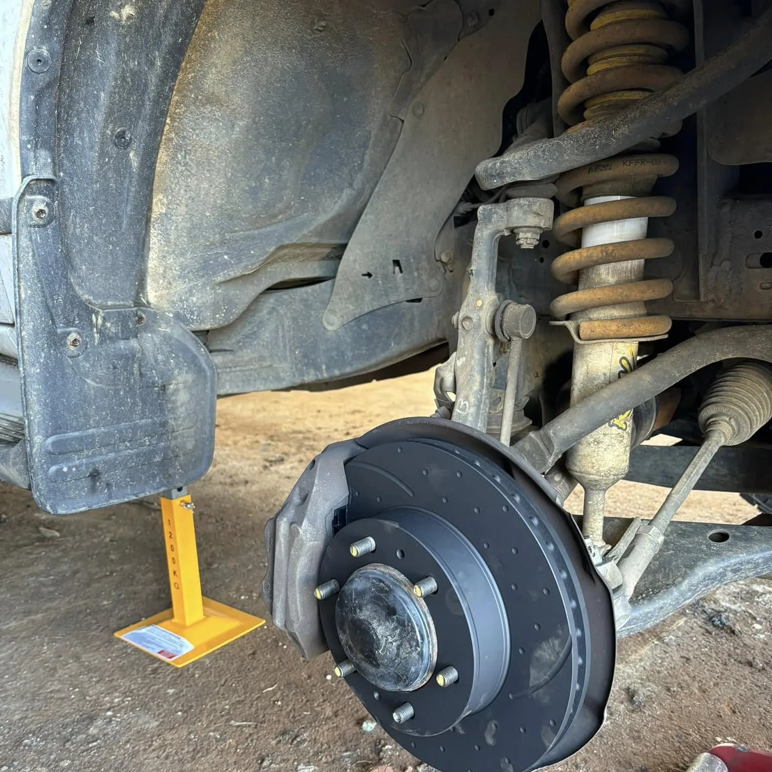 Coil spring, hub and brake assembly stripped on a four wheel drive in a driveway