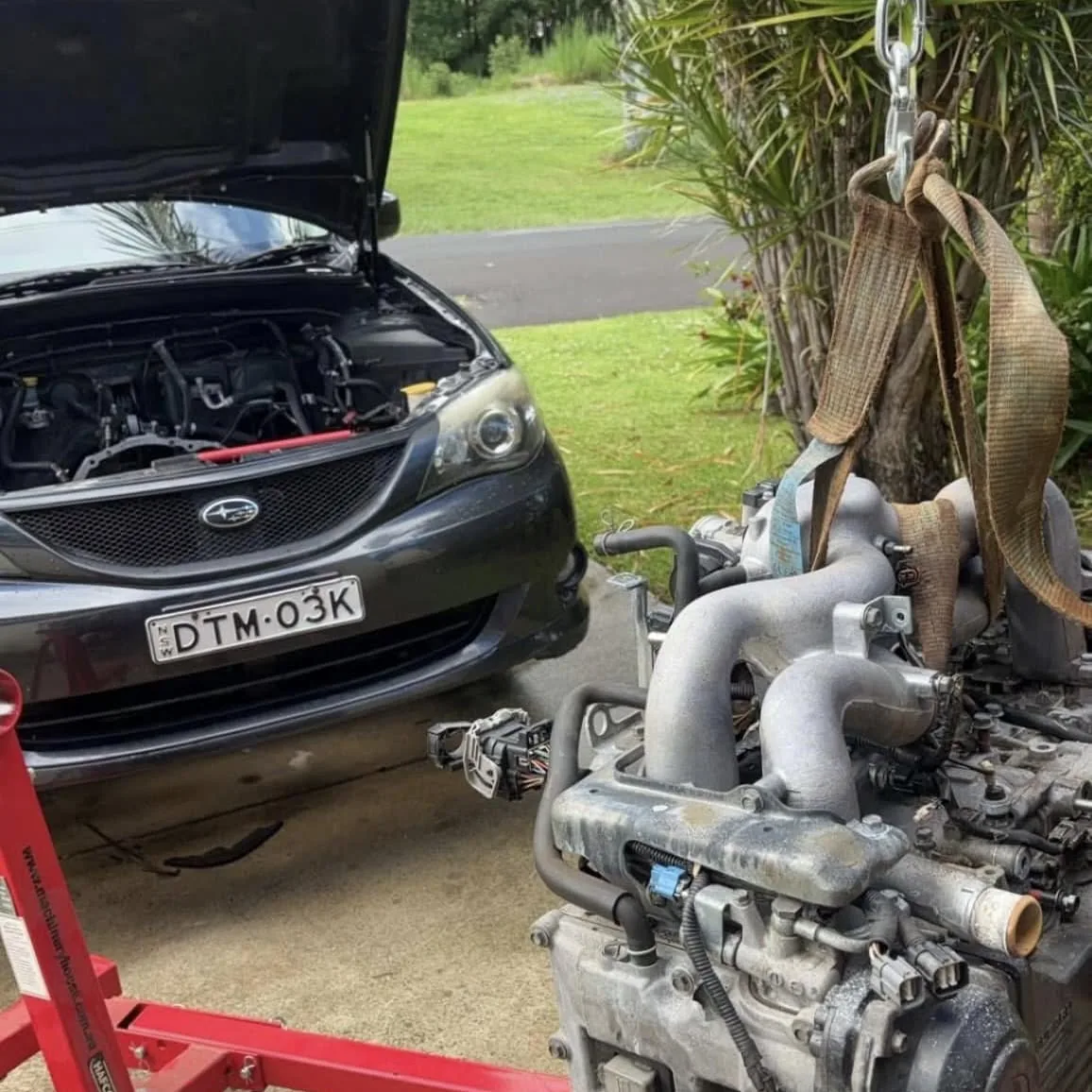 Subaru WRX with the engine and turbo assembly removed on site